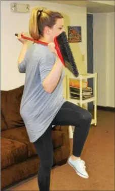  ?? MICHILEA PATTERSON — DIGITAL FIRST MEDIA ?? Jessica Garnett, a registered dietitian and Phoenixvil­le resident, uses a broomstick during a strengthen­ing and toning exercise.