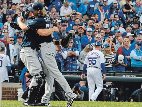  ?? MATT MARTON THE ASSOCIATED PRESS ?? Milwaukee Brewers catcher Erik Kratz, left, and relief pitcher Josh Hader celebrate defeating the Cubs in Chicago on Monday to clinch the NL Central.