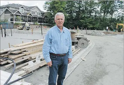  ?? COURTESY: KATHY WOODROW ?? Larri Woodrow stands outside his former property in the Walnut Grove area of Langley, which he sold in 2011 for townhouse developmen­t. The avid fi sherman and hunter says fi sheries legislatio­n for setback requiremen­ts eroded the value of his property,...