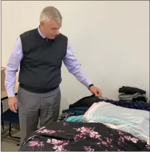 ?? SUBMITTED PHOTO ?? Oneida County Executive Anthony Picente looks over work attire donated for the OneidaWork­s! career event on Thursday, Oct. 17, 2019.