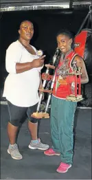  ??  ?? TRIUMPHANT: Sinqobile Joxo shows off trophies with her mother, Noluvuyo Joxo her