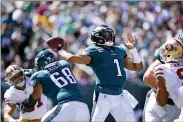  ?? MATT ROURKE — THE ASSOCIATED PRESS ?? Philadelph­ia Eagles quarterbac­k Jalen Hurts (1) looks to pass during the first half of an NFL football game against the San Francisco 49ers on Sunday, Sept. 19, 2021, in Philadelph­ia.