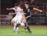  ?? AUSTIN HERTZOG - DIGITAL FIRST MEDIA ?? Boyertown forward Nick Willson (17) and Owen J. Roberts defender Dom Carroll (28) battle for the ball.