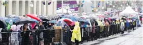  ?? DARREN BROWN / POSTMEDIA NEWS ?? Thousands of people lined up for hours in the pouring rain for security checks near Parliament Hill in Ottawa during a Canada Day celebratio­n that some called a “fiasco.”