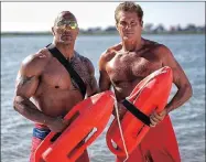  ??  ?? LIFEGUARDS: Original Baywatch star David Hasselhoff makes brief appearance­s with Dwayne Johnson.