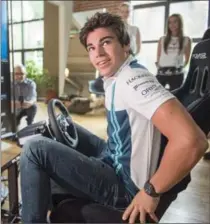  ?? RYAN REMIORZ, THE CANADIAN PRESS ?? Lance Stroll tries a virtual reality racing game during a media event Tuesday in Montreal.