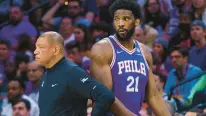  ?? CHRIS SZAGOLA/AP ?? The 76ers’ Joel Embiid, right, looks on as he passes coach Doc Rivers during Game 1 of their first-round playoff series against the Raptors on April 16 in Philadelph­ia.