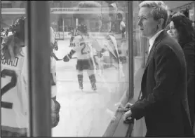  ?? Associated Press Packer of the ?? Profession­al Women’s Hockey League New York player Madison watches as her team warms up on Monday for the inaugural game PWHL in Toronto. Packer sat out due to an injury.