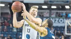  ?? JULIE JOCSAK THE ST. CATHARINES STANDARD ?? Adam Klie of the Niagara River Lions looks to get the ball past Ryan Reid of the St. John's Edge in NBL action Thursday night at Meridian Centre in St. Catharines.
