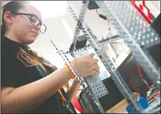  ??  ?? Lodi Middle Robotics team member Madison Gallardo, 13, works on her robot on Thursday. One of the other robotics teams will be traveling to the Google campus in Mountain View on Saturday for its first competitio­n.