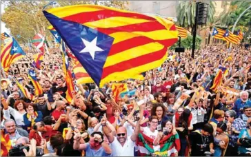  ?? PAU BARRENA/AFP ?? People celebrate after Catalonia’s parliament voted to declare independen­ce from Spain in Barcelona on October 27.