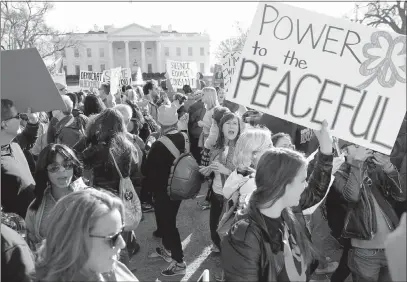  ?? PABLO MARTINEZ MONSIVAIS / ASSOCIATED PRESS FILE ?? Women’s March demonstrat­ors walk past the White House on Jan. 20. Gender politics were the defining issue of this election cycle, beginning with the mobilizati­on by women against the election and inaugurati­on of President Donald Trump.