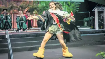  ?? JOSE A. IGLESIAS jiglesias@elnuevoher­ald.com ?? Maddie Clinger — the first female Sebastian, the school mascot — leads graduates and guests in a C-A-N-E-S cheer at a University of Miami graduation ceremony on Friday in Coral Gables.