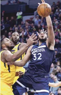  ?? AP ?? Karl Towns disputa el balón con un par de jugadores del Jazz de Utah en el partido en que perdió su equipo.