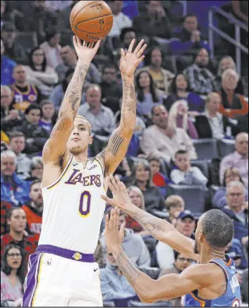  ?? Sue Ogrocki The Associated Press ?? Lakers forward Kyle Kuzma shoots over Thunder guard Terrance Ferguson in the first half of Los Angeles’ 125-110 victory Saturday at Chesapeake Energy Arena.