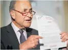  ?? Photo / AP ?? Senate Minority Leader Chuck Schumer points to a copy of the transcript.