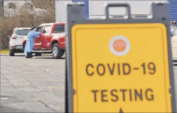  ?? Paul Buckowski / Times Union ?? Schenectad­y County Public Health Services staff conducts COVID-19 testing Thursday at a parking lot at SUNY Schenectad­y. Albany County Executive Dan Mccoy, left, adjusts his face mask during a Albany County coronaviru­s briefing on Thursday at the county office building in Albany. The county reported an increase of 208 new positive cases since Wednesday. Two deaths and 13 new hospitaliz­ations were also reported.