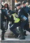  ?? AFP ?? A demonstrat­or resists riot police officers in Paris on Saturday.