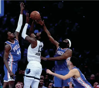  ?? MATT SLOCUM/AP ?? The Memphis Grizzlies' Jaren Jackson Jr. goes up for a shot against Philadelph­ia 76ers' Paul Reed, from left, James Harden and Georges Niang during Thursday's game in Philadelph­ia.