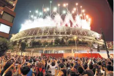  ?? KYODO NEWS/AP ?? People gather around the National Stadium to watch the fireworks display launched during the closing ceremony of the Tokyo Olympics Sunday. When the Tokyo Olympics began during a worsening pandemic, the majority of the host nation was in opposition, with Emperor Naruhito dropping the word of celebratio­n from his opening declaratio­n of welcome. But once the Games got underway and local media switched to covering Japanese athletes’ medal rush, many were won over.