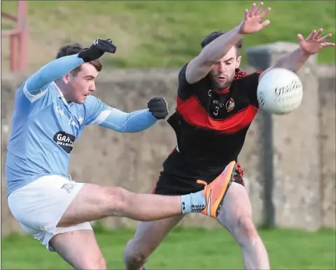  ??  ?? Dermot Campbell blocks down shot by Ross Nally during the Blues win over Dreadnots on Sunday.