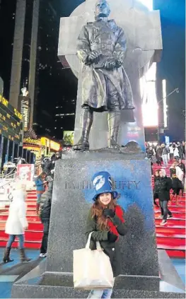  ??  ?? SAY ‘FREEZE‘: The writer wraps up warmly in front of the Father Duffy monument in New York’s Times Square