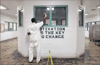  ?? JAY JANNER / AMERICAN-STATESMAN ?? An inmate cleans a housing area at the Travis County State Jail. Texas’ state jails have fewer treatment and rehab programs than many regular prisons — the opposite of the original goals.