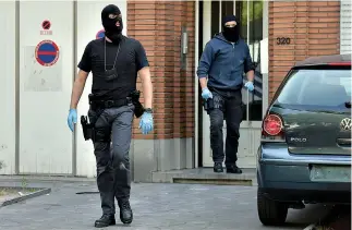  ?? REUTERS ?? BELGIAN POLICEMAN get out of a house after searching it, following yesterday’s attack, in Brussels, Belgium June 21.