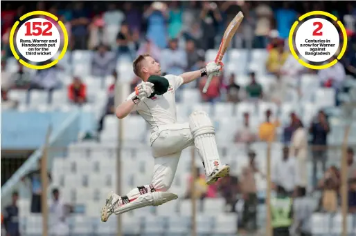  ?? AP ?? Australia’s David Warner jumps in the air in celebratio­n after scoring his century on the third day of their second Test match against Bangladesh. —