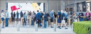  ??  ?? People wait Friday for the iphone 11 release at the Apple Store at Downtown Summerlin.