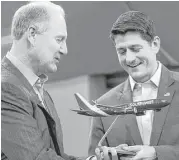  ?? Sergio Flores / Bloomberg ?? Gary Kelly, chairman and chief executive officer of Southwest Airlines, left, presents a model plane to U.S. House Speaker Paul Ryan during a Southwest town hall event this week in Dallas.