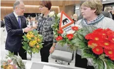  ?? — Reuters ?? The reelected Lower Saxony Prime Minister Stephan Weil (SPD) receives flowers from Meta Janssen-Kucz of the Green Party in Hanover on Wednesday.