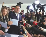  ?? (Murad Sezer/Reuters) ?? ISTANBUL MAYOR Ekrem Imamoglu, mayoral candidate of the main opposition Republican People’s Party (CHP), and his wife Dilek Imamoglu, vote during the local elections in Istanbul yesterday.