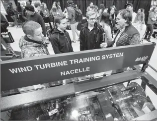  ?? Herald photo by Ian Martens @IMartensHe­rald ?? Calvin Christian Grade 11 students Justin Neels, Layton VandeStroe­t and Derek van de Bruinhorst talk with Wind Turbine Technician instructor Ron Papp during an open house event Thursday at Lethbridge College.