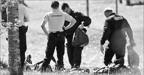  ??  ?? French police officers and bomb-disposal experts are seen during investigat­ions in Saint-Pee-sur-Nivelle near Bayonne, France after Basque militant separatist group ETA passed a list with the location of its arms caches to French authoritie­s,...