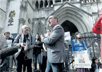  ?? JONATHAN BRADY/PA VIA AP ?? Reverend Patrick Mahoney from Washington D.C., centre, speaks to the media outside the Royal Courts of Justice in London, as he joins other Charlie Gard supporters, on Sunday.