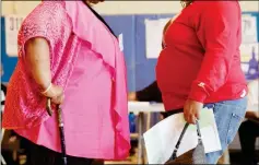  ?? ASSOCIATED PRESS ?? IN THIS 2012 FILE PHOTO, TWO WOMEN CONVERSE in New York. New government figures released Friday showed small increases that were not considered statistica­lly significan­t but were seen by some as a cause for concern. The adult obesity rate rose from to...