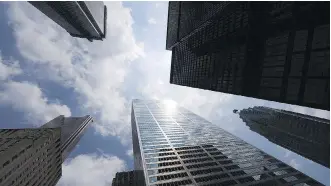  ?? THE CANADIAN PRESS/FILES ?? Bank towers loom over Bay Street in Toronto’s financial district. The Liberals went to their default position by deciding that Toronto will be the headquarte­rs of the new infrastruc­ture bank, writes Deborah Yedlin.