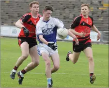  ??  ?? Enda Wallace of Ballyhogue is chased by Mark Wallace and Nicky Doyle of Bannow-Ballymitty.