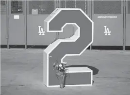  ?? MARCIO JOSE SANCHEZ/AP ?? Flowers are placed in front of Tommy Lasorda’s retired No. 2 on Friday at Dodger Stadium in Los Angeles. Lasorda died Thursday night.