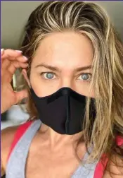  ??  ?? Friendly advice: Jennifer Aniston shows how it’s done with a black Wolford mask