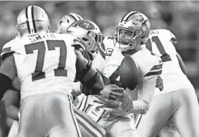  ?? TIM HEITMAN/USA TODAY SPORTS ?? Cowboys quarterbac­k Dak Prescott fumbles as he is sacked by 49ers defensive end Charles Omenihu on Sunday.