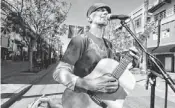  ?? SONDRA STOCKER ?? Strumming his guitar, a street performer provides light entertainm­ent in Santa Monica.