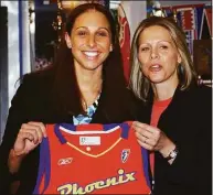  ?? Associated Press file photo ?? UConn’s Diana Taurasi, left, is presented with a Phoenix Mercury jersey by WNBA President Val Ackerman after the Mercury chose her as the No. 1 overall pick in the 2004 WNBA draft.