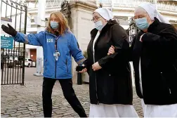  ??  ?? This way...nuns arrive for jabs at Lord’s cricket ground, London