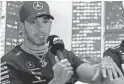  ?? RYCROFT/AP RICK ?? Mercedes driver Lewis Hamilton, seen March 12, says the idea of driving around Formula One tracks without fans would feel “very empty.”