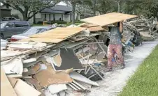  ?? Jay Janner/Austin American-Statesman via AP ?? A worker for a contractor guts a flood-damaged home Friday in the Meyerland neighborho­od in Houston.