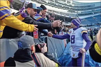  ?? Matt marton/uSa today Sports ?? Minnesota Vikings quarterbac­k Kirk Cousins (8), shown here greeting fans after the game against the Chicago Bears at Soldier Field, and his team will open the NFL playoffs this weekend against the New York Giants.