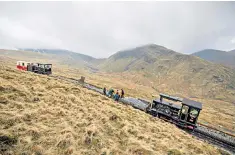  ??  ?? Engineers test one of the steam trains, left; the railway’s longest serving member of staff, Gwyn Jones at work cutting steel, right; engineers working on the new track in readiness for the reopening next weekend, top right