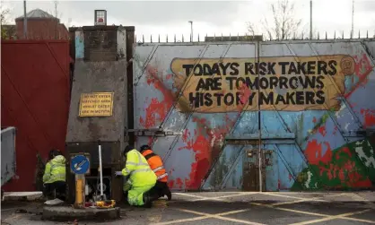  ??  ?? The peace gates in Lanark Way being repaired after violence the night before, Belfast, NorthernIr­eland, 9 April 2021. Photograph: Mark Marlow/EPA